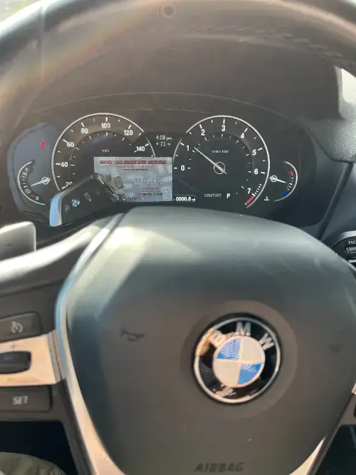 Bmw Key Fob On Family Sedan Steering Wheel Grip - EZ Car Keyz Otay Ranch, Chula Vista