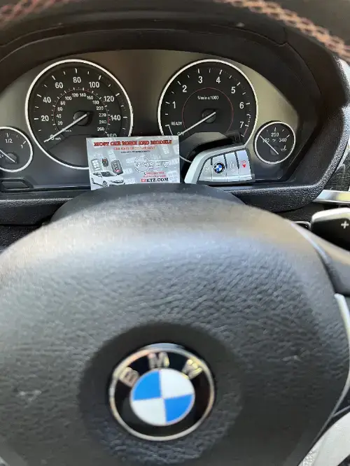 Bmw Smart Key Fob On Compact Car Dashboard Surface - EZ Car Keyz Otay Ranch, Chula Vista